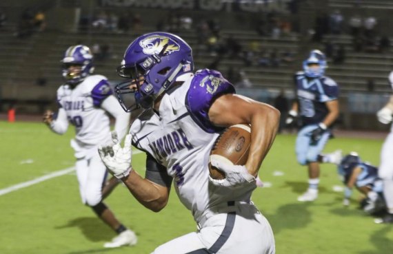 Lemoore's Brandon Hargrove scores on 33-yard run for Tigers only offensive touchdown against Redwood High School Friday night in Visalia.